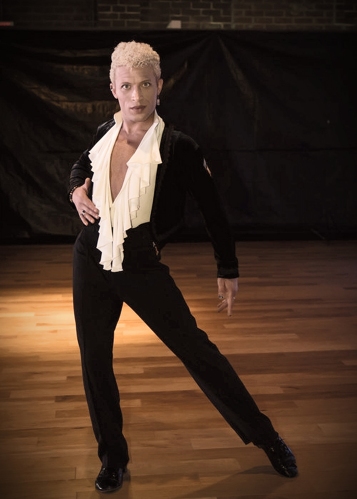 Blayne Allen posed in a black velvet jacket on the dance floor
